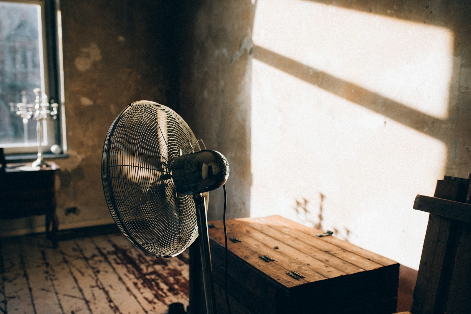 Floor fan running in a room during water damage drying